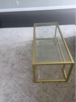 Glass coffee table with gold detail