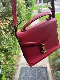 red Saint Laurent Cassandra Top Handle Bag crafted in textured grain de poudre leather with signature gold-toned hardware