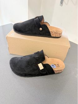 black faux suede slip-on clogs featuring an adjustable buckle strap size 8.5