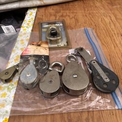 Various Sizes Of Pulleys And Combination Lock 
