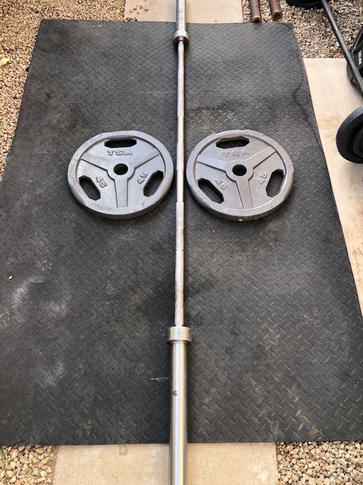 Weight plates and barbell.... 45 pound Olympic Bar ,with TWO 45 pound weight plates..$240 OBO