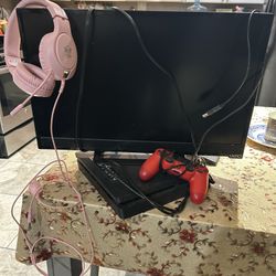 Black PS4 Console with Red Controller and monitor