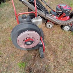 Troy bilt walk behind leaf blower and and Troy bilt 10 horsepower chipper And several riding mowers