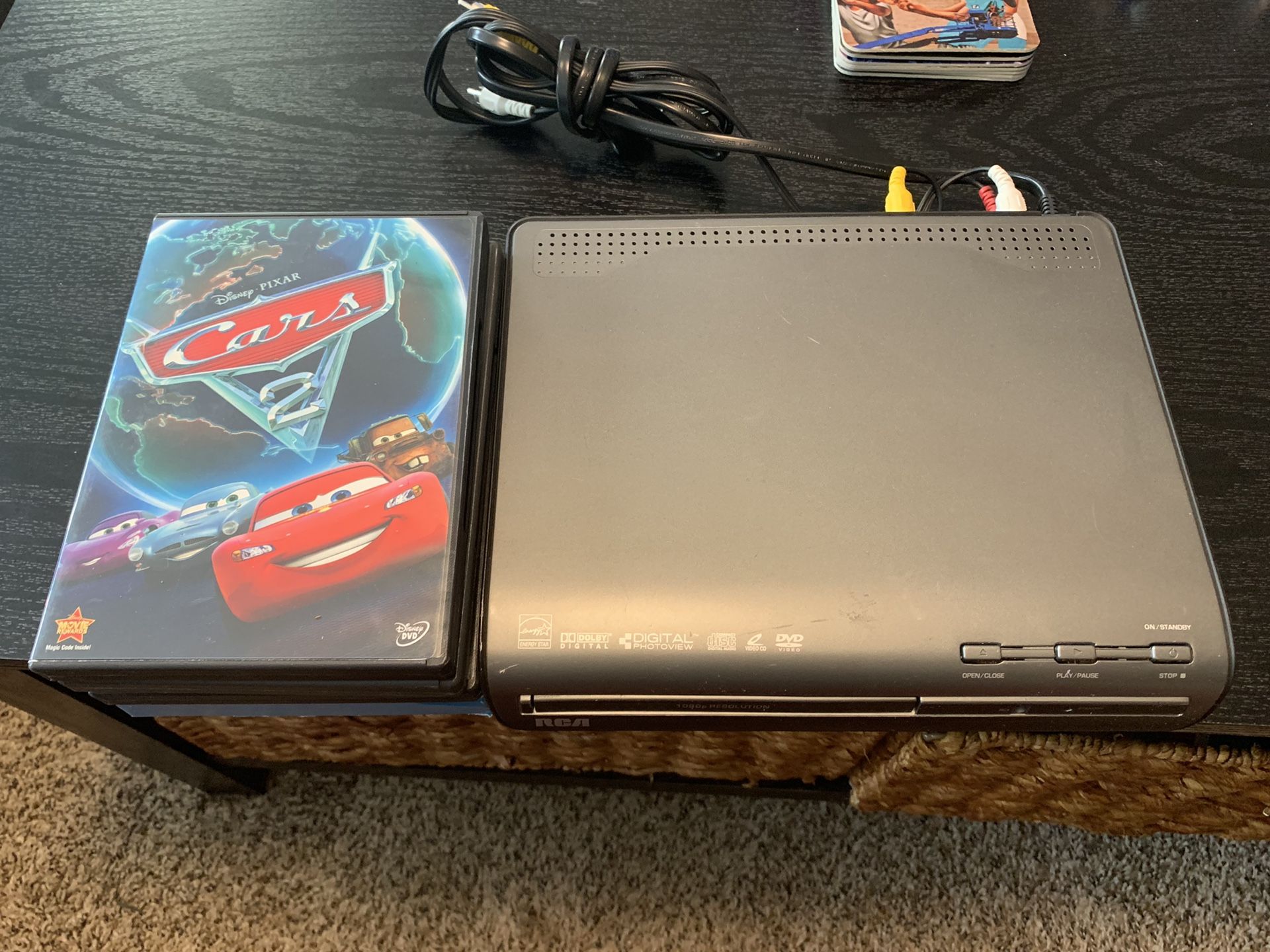 RCA DVD player w/ dvds (cars 2,old school, Batman, family guy)