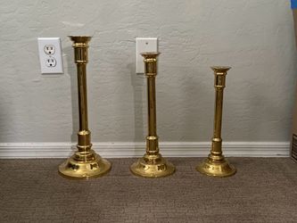 3 large gold candle stick holders