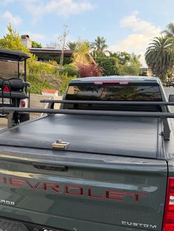 Tonneau bed cover with included rack
