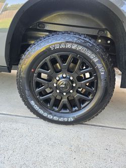 Firestone Transforce AT2 Tire on Black Alloy Wheel