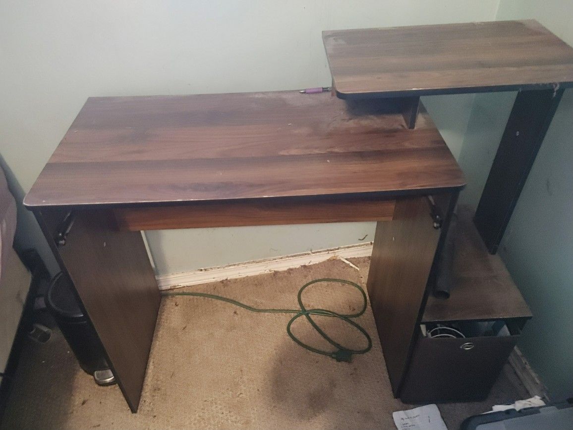 Brown Ikea desk with monitor stand and some storwge