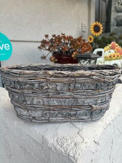 Lined rustic oval planter basket made from woven twigs and natural birch