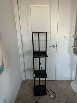 Tall black floor lamp with USB and shelves