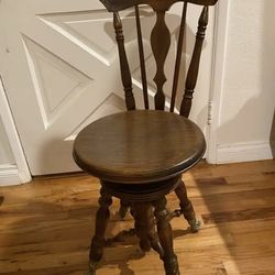Antique piano stool with classic styling.