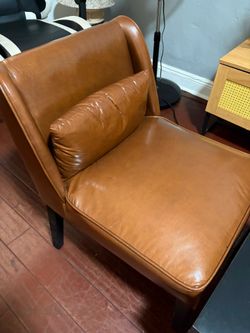 Two modern cognac accent chairs