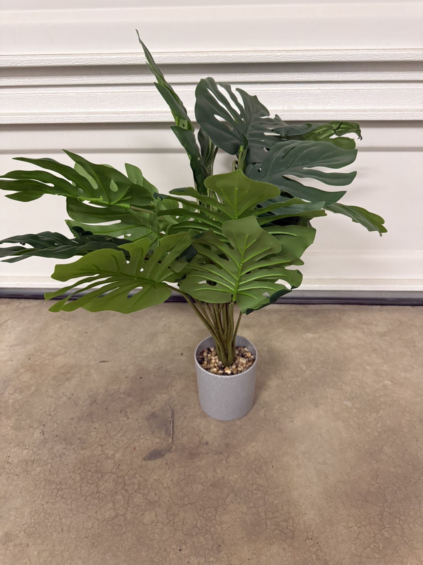 Small artificial decorative plant with vase.