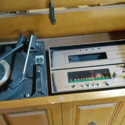Eight-track record player stereophonic sound two separate speakers it's really a piece of furniture been downstairs covered up for 10 years