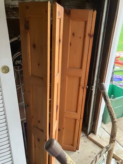 Two pine bifold doors measuring 60 1/2 x 20 each