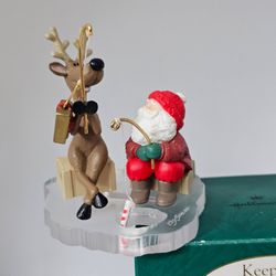 Hallmark Ornament Ice Fishing for Fun 1995 Santa Reindeer Clip on candy cane

Ornament is in great condition,  no flaws 
Handcrafted  - dated 1995 Kee