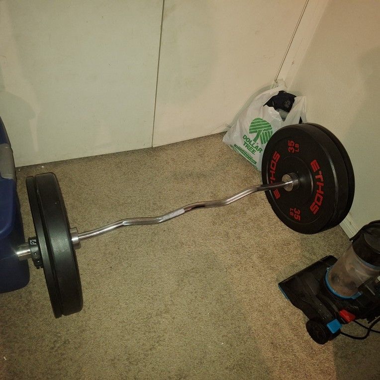 Curl Bar With Two 35 Pound Weights And Two 10 Pound Weights