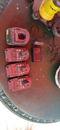 Three batteries and charger with two ryobi edgers