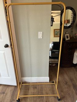 Two gold clothes racks