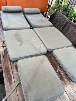 Set of 2 Domus Brand steamer chair cushions in light green  Located in concord  Measures 75” long.       20” wide.         2.5” thick   Note: burn mar