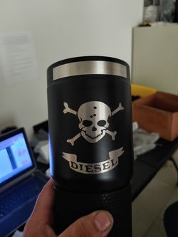 Stainless steel black powder coated Tumbler 32oz caterpillar is the brand of the cup $25 dollar was laser etched