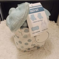 Cozy Kit gift set containing two pairs of fuzzy socks, one fuzzy headband, and a reusable tote.