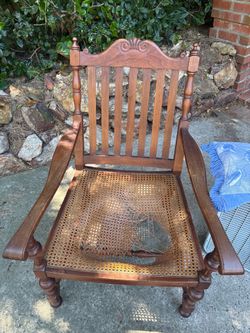 Vintage wooden armchair with cane seat