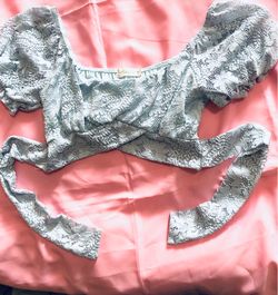 Beautiful Altar'd State lace crop top is light blue.
