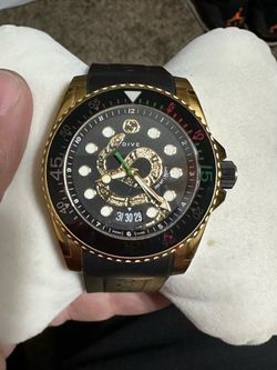 Black and Gucci dive watch with snake motif and rubber band