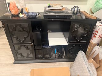 Spacious entertainment center with decorative doors