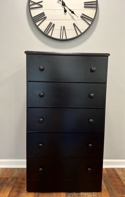 Tall black chest of drawers with 5 drawers in a classic style.