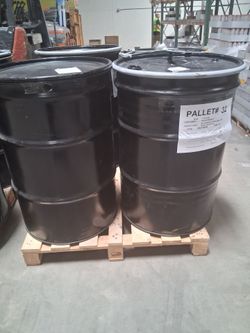 Large Black Steel Drums on Pallet