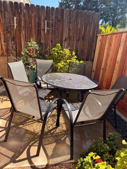 Round Black Wrought Iron Patio Table and Six Chairs