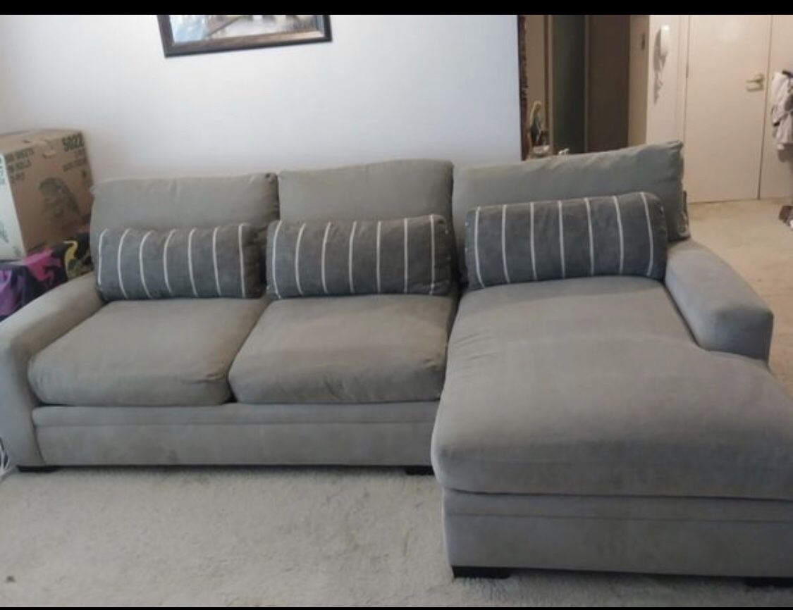 Rarely used grey sectional sofa couch with 3 pillows