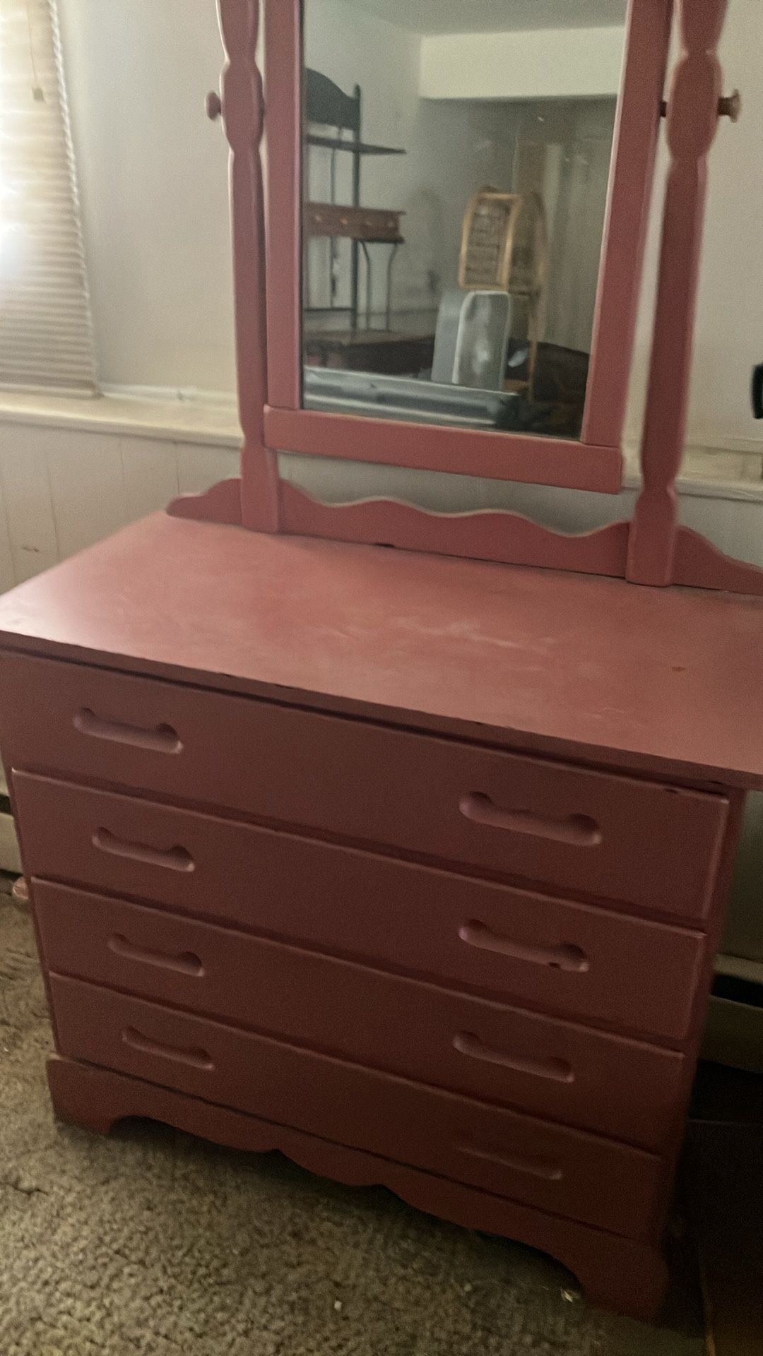Pink dresser with a mirror