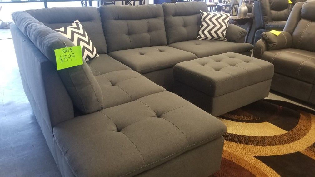 New charcoal grey sectional with storage ottoman included