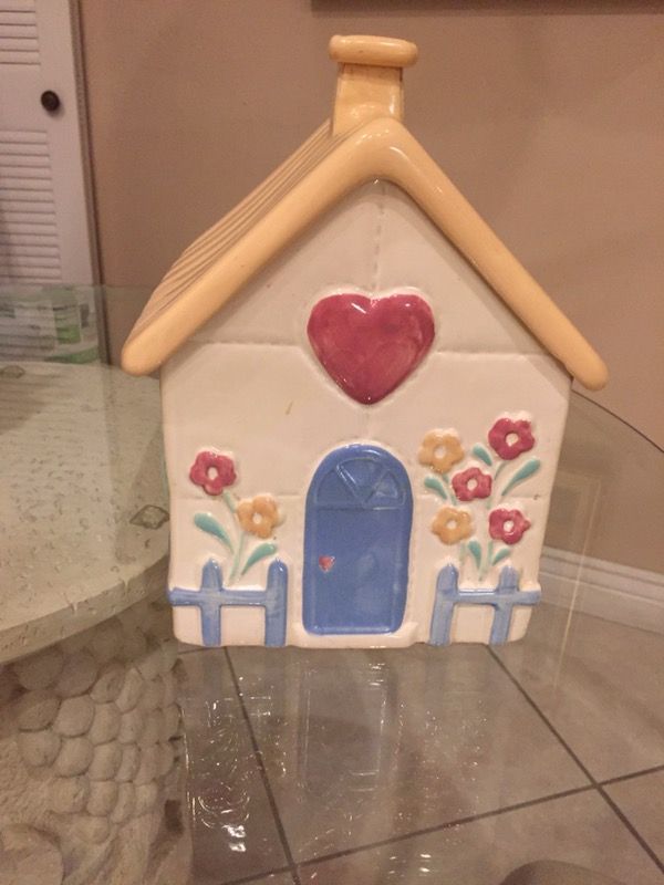 Cookie Jar in the shape of a house, has small chip on chimney.