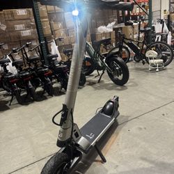 Folding electric scooter with shock absorption