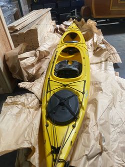 This is a yellow Riot Polarity 16.5 tandem kayak, recognized for its stability and speed in rotomolded tandem kayaks.This model features a unique cata