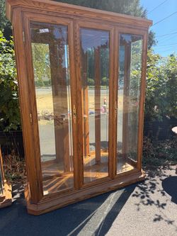 Solid oak curio cabinet.
