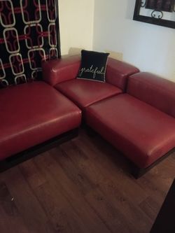 Red modern sofas and ottomans. Slightly used.