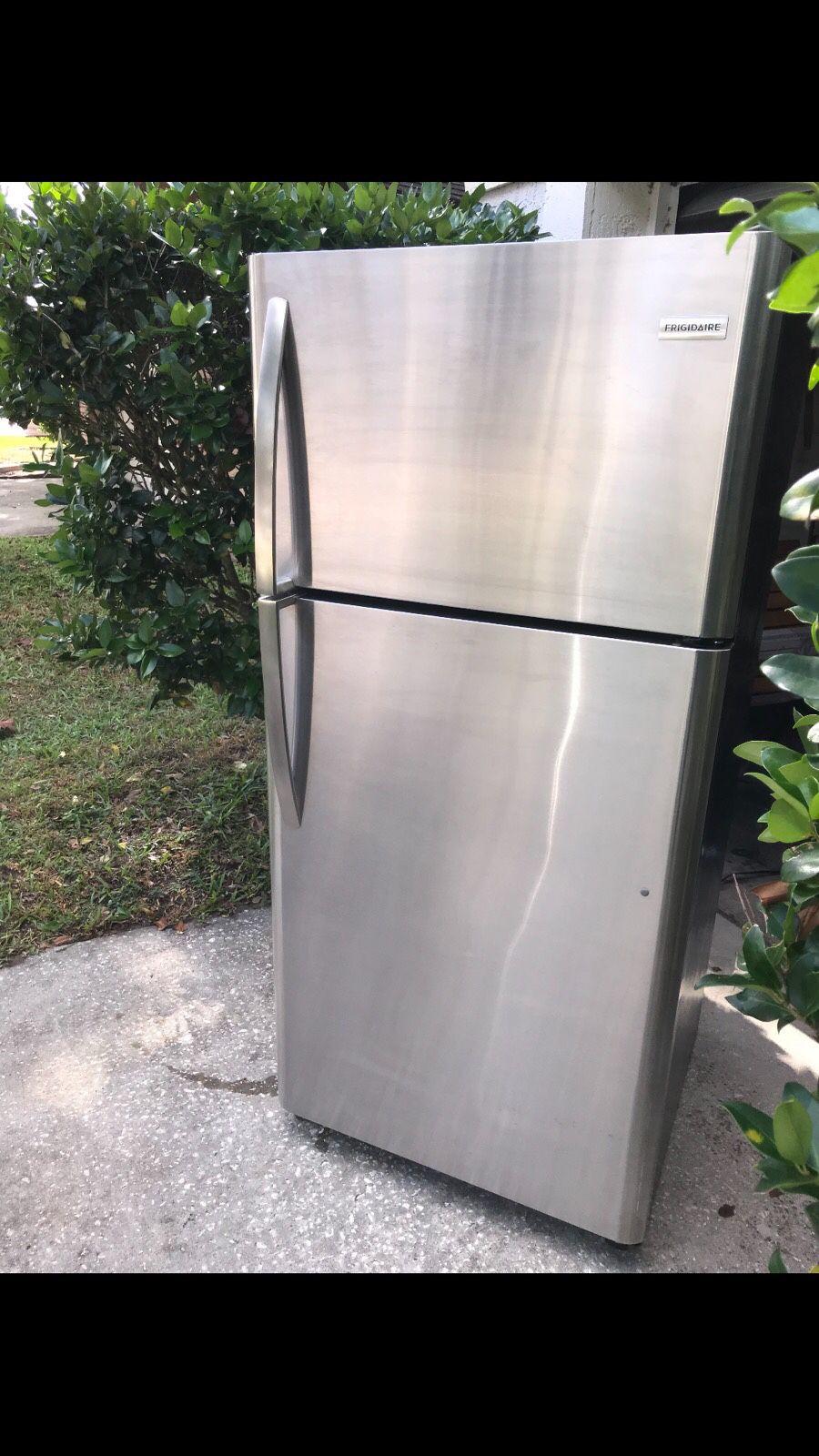 This is a Frigidaire top freezer refrigerator stainless steel and black model number FFTR1821Ts4 super clean works great looks great ice cold top and