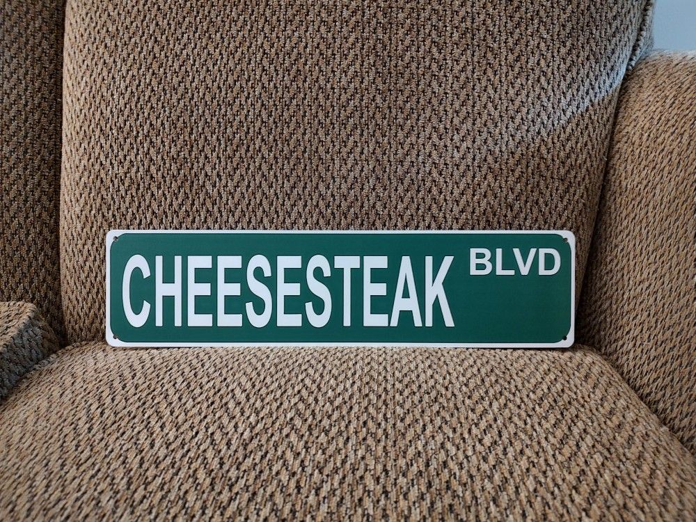 CHEESESTEAK BLVD. METAL SIGN. 16" X 4". NEW. PICKUP ONLY.