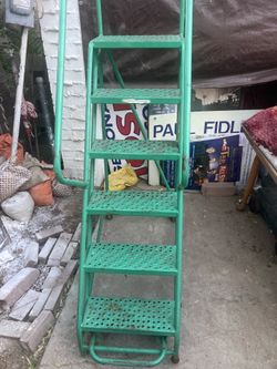 Metal safety ladder on wheels