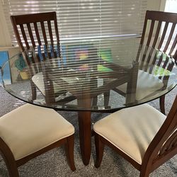 Glass top table and four chairs