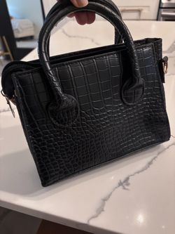 Woman’s small black snake print bag