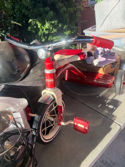 Radio flyer tricycle pink and a red one