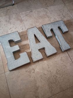 E A T letters sign