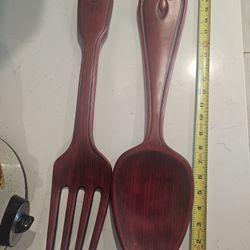 Large red wooden spoon and fork.