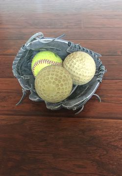 Softball glove and three Softball balls